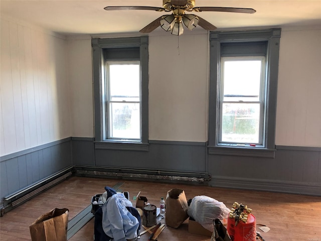 unfurnished room featuring hardwood / wood-style flooring, plenty of natural light, and ceiling fan