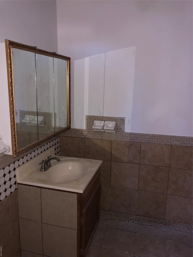 bathroom featuring tile patterned floors, vanity, and tile walls