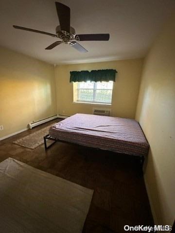 bedroom featuring baseboard heating and ceiling fan