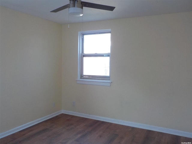 spare room with dark hardwood / wood-style floors and ceiling fan