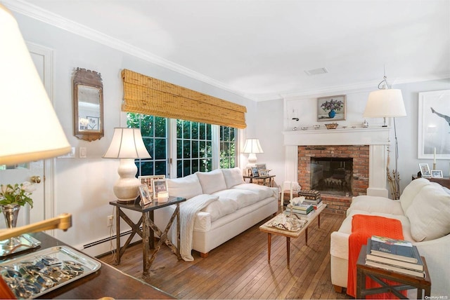 living room featuring a fireplace, a baseboard heating unit, hardwood / wood-style flooring, and ornamental molding