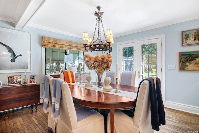 dining room with wood-type flooring, crown molding, a wealth of natural light, and french doors