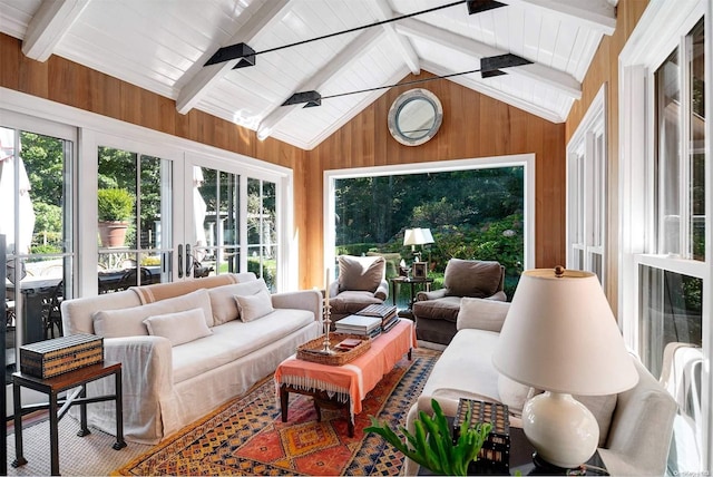 sunroom / solarium featuring ceiling fan and lofted ceiling with beams