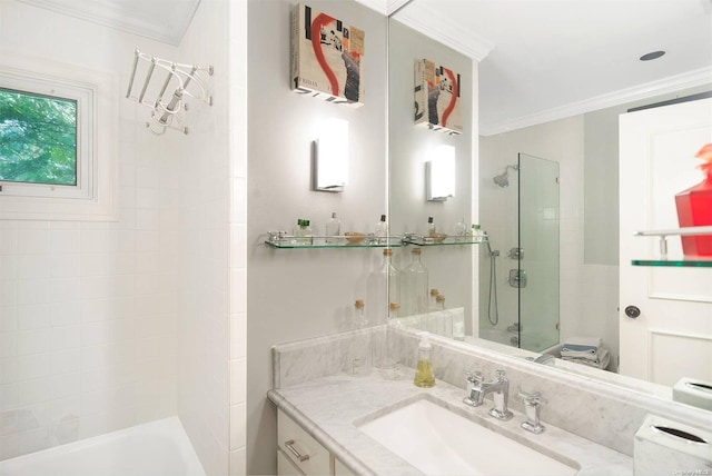 bathroom with vanity, ornamental molding, and tiled shower