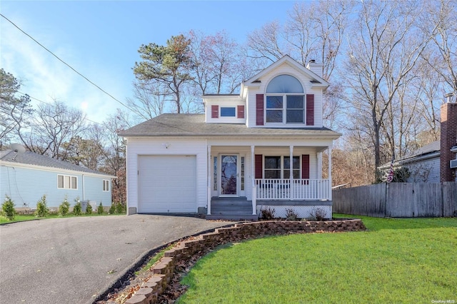 view of property with a front lawn, covered porch, and a garage