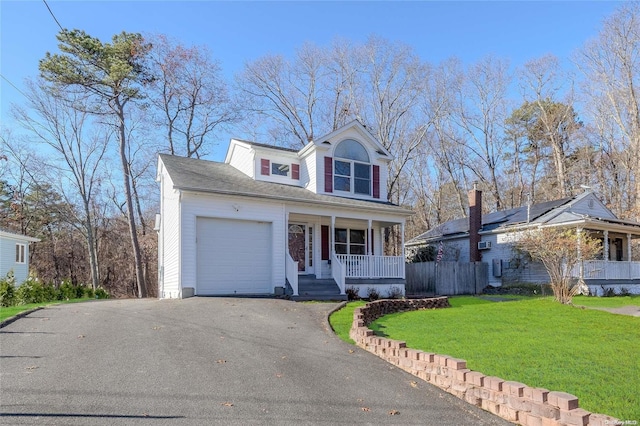 front facade featuring covered porch, a garage, and a front lawn