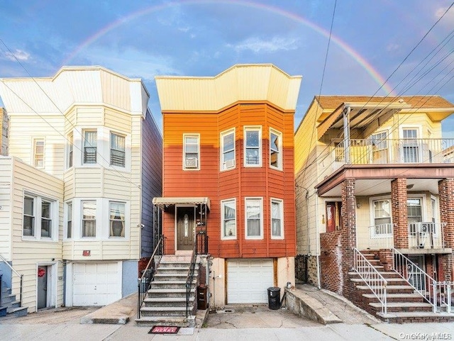 townhome / multi-family property featuring a balcony and a garage