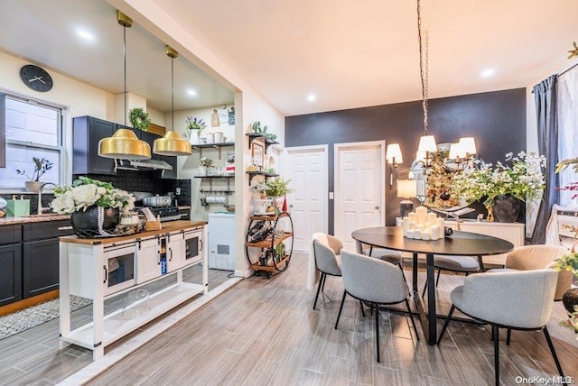 dining room featuring a chandelier, wood-type flooring, and sink