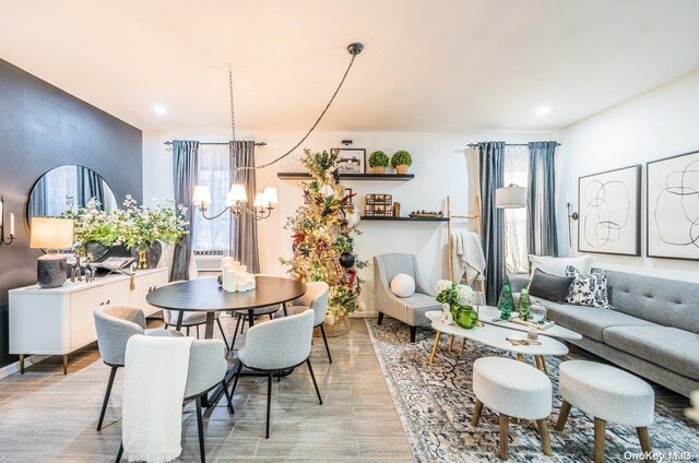 dining room with light hardwood / wood-style flooring and an inviting chandelier