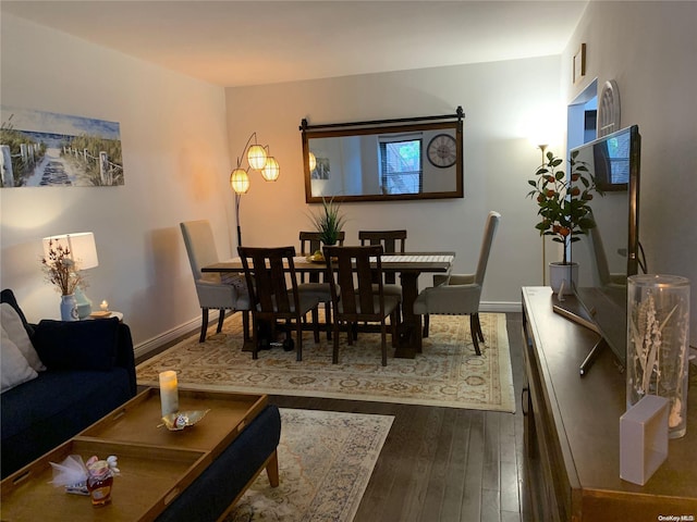 dining space with hardwood / wood-style floors