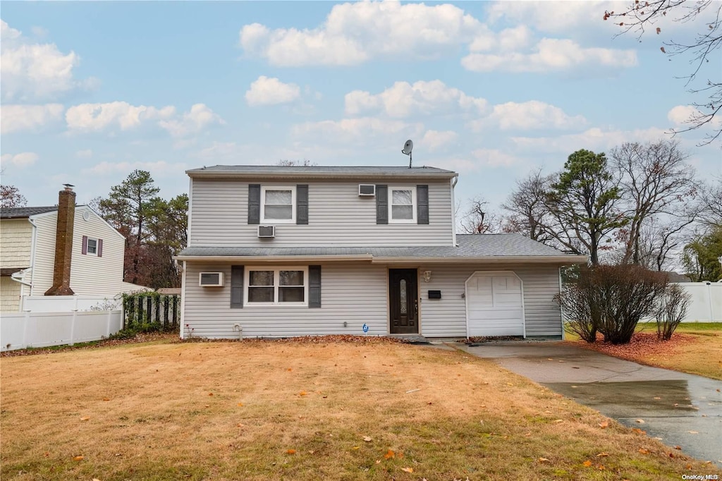 front of property featuring a garage and a front lawn