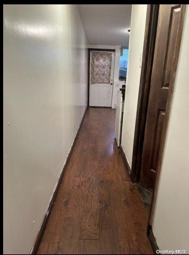 corridor featuring dark hardwood / wood-style floors