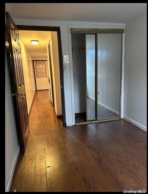 unfurnished bedroom with a closet and wood-type flooring