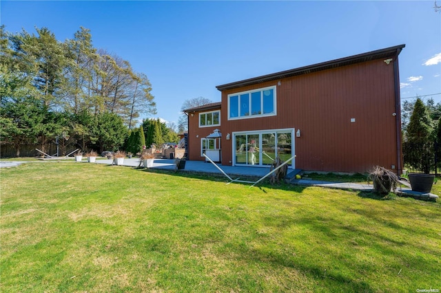 back of property featuring a yard and a patio