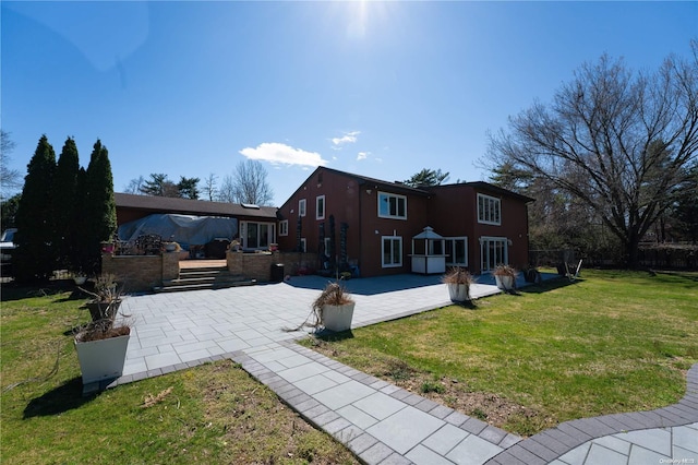 back of house featuring a patio area and a yard