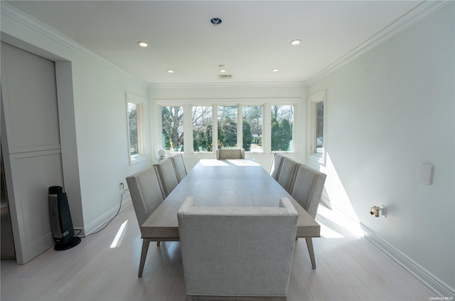 dining area featuring light hardwood / wood-style floors and ornamental molding