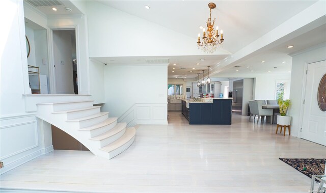 stairs with hardwood / wood-style flooring and a notable chandelier