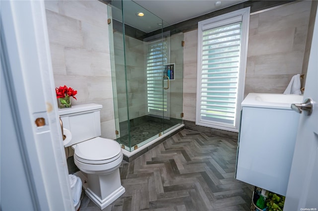 bathroom featuring plenty of natural light, an enclosed shower, and tile walls