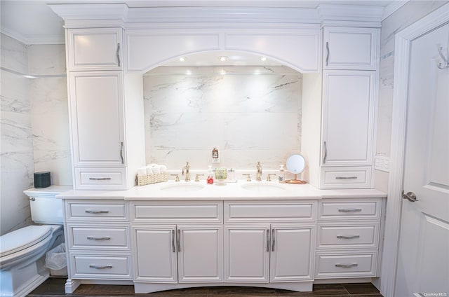 bathroom with vanity, toilet, crown molding, and tile walls