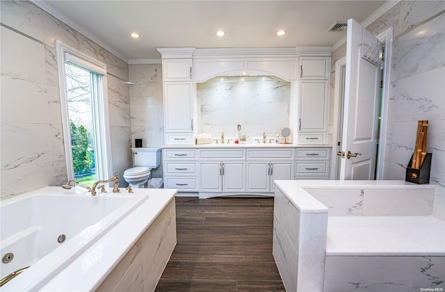 bathroom featuring vanity, a bath, toilet, ornamental molding, and wood-type flooring