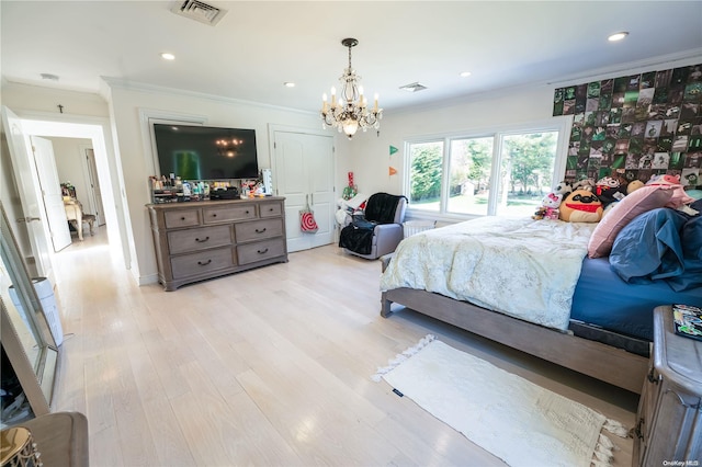 bedroom featuring an inviting chandelier, light hardwood / wood-style flooring, and ornamental molding