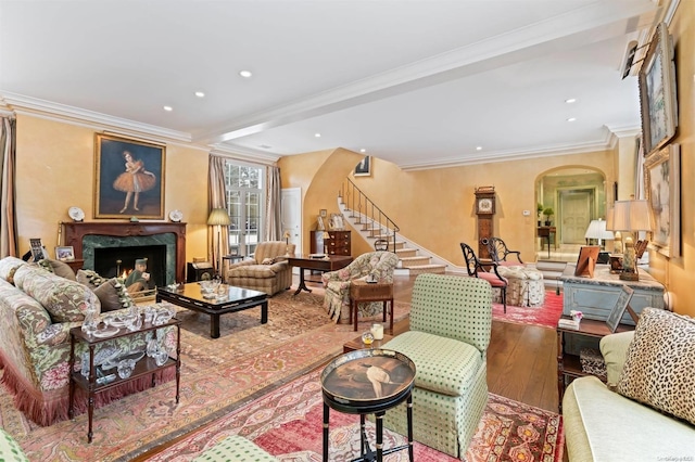 285 Piping Rock Rd, Locust Valley, NY 11560 - living area featuring arched walkways, hardwood / wood-style floors, stairs, a fireplace, and ornamental molding