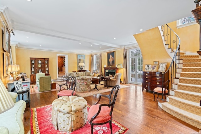 living room featuring french doors, light hardwood / wood-style floors, and ornamental molding