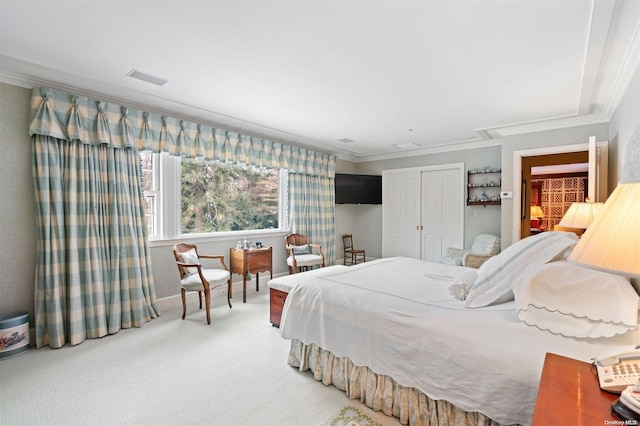 bedroom with carpet flooring, crown molding, and a closet