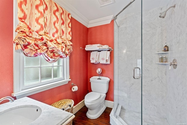 bathroom with hardwood / wood-style floors, toilet, vanity, a shower with shower door, and ornamental molding