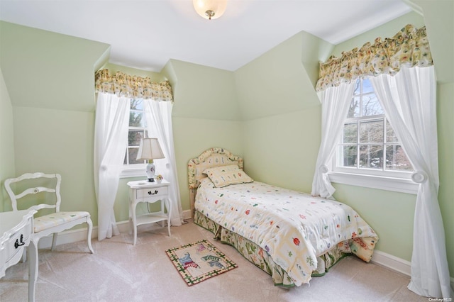 carpeted bedroom featuring multiple windows