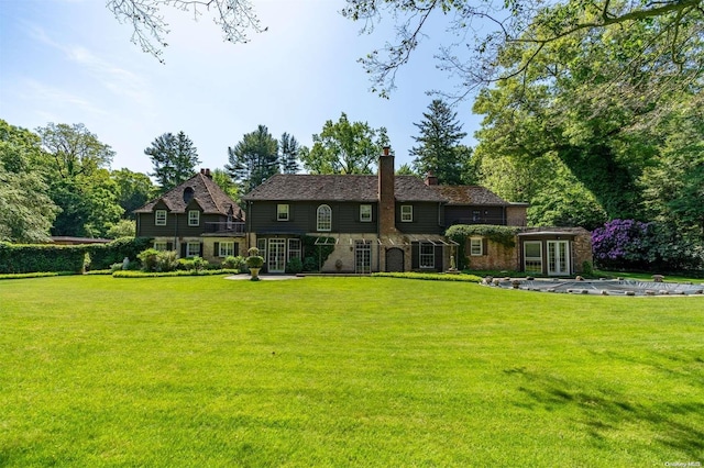 view of front of property featuring french doors and a front yard