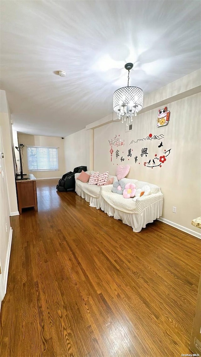 unfurnished bedroom featuring hardwood / wood-style floors and an inviting chandelier