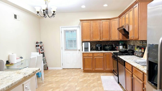 kitchen with backsplash, light stone counters, stainless steel appliances, a notable chandelier, and hanging light fixtures