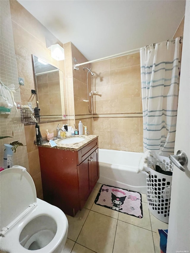 bathroom featuring tile patterned floors, tile walls, vanity, and shower / tub combo