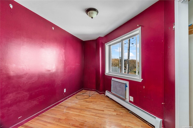 spare room featuring light hardwood / wood-style flooring and a baseboard heating unit