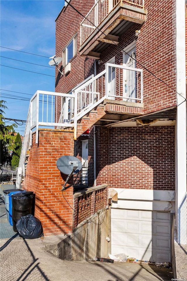 exterior space with a garage and a balcony