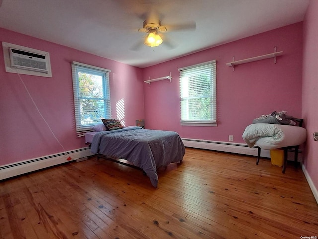 bedroom featuring hardwood / wood-style floors, ceiling fan, baseboard heating, and a wall mounted AC