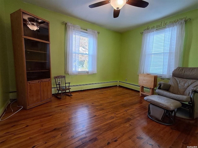 sitting room featuring ceiling fan and dark hardwood / wood-style floors