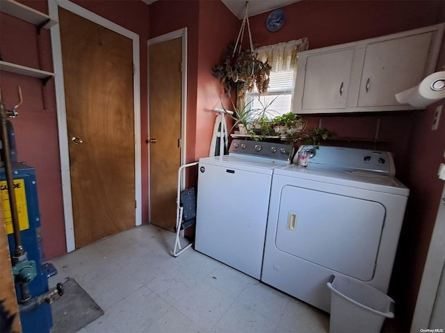 clothes washing area featuring separate washer and dryer and water heater