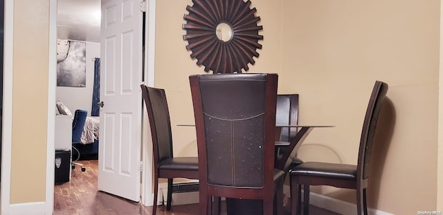 dining area featuring dark wood-type flooring