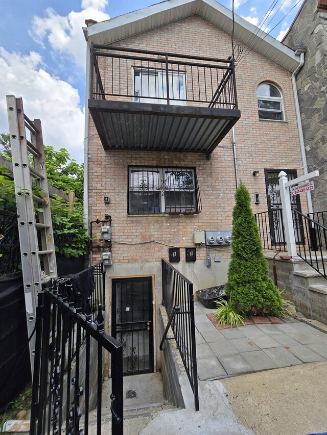 607 Ashford St, Brooklyn, NY 11207 - view of front of house featuring a balcony and brick siding