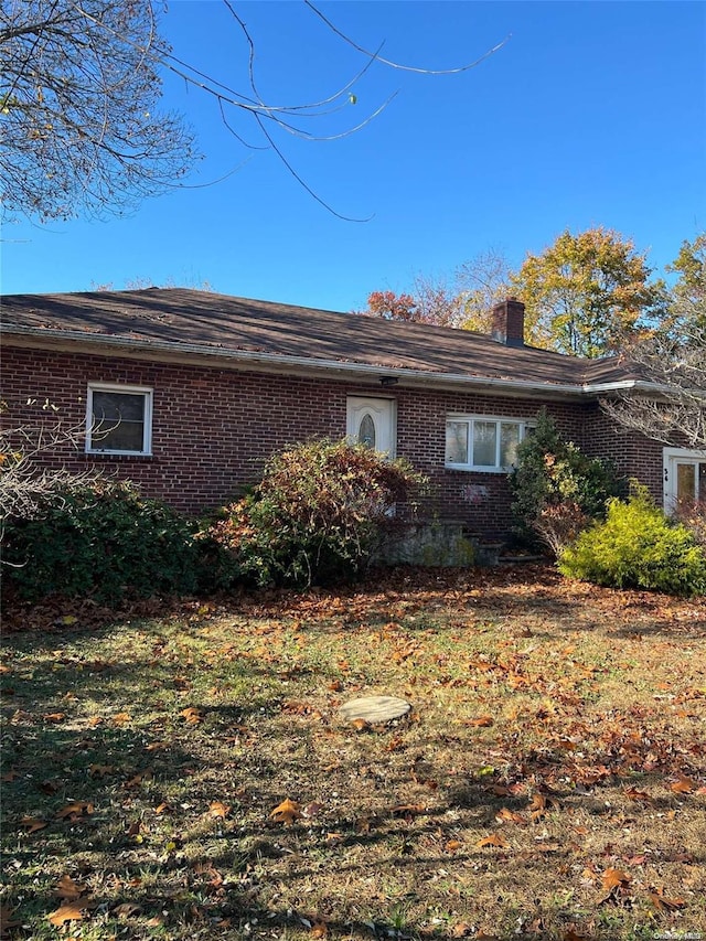 view of side of home featuring a lawn