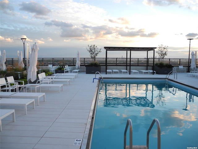 view of pool at dusk