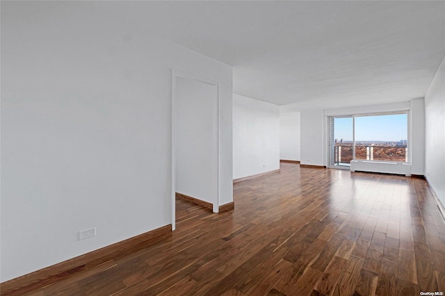 unfurnished room with dark wood-type flooring