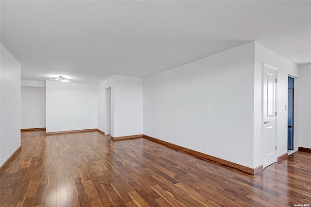 empty room with dark wood-type flooring