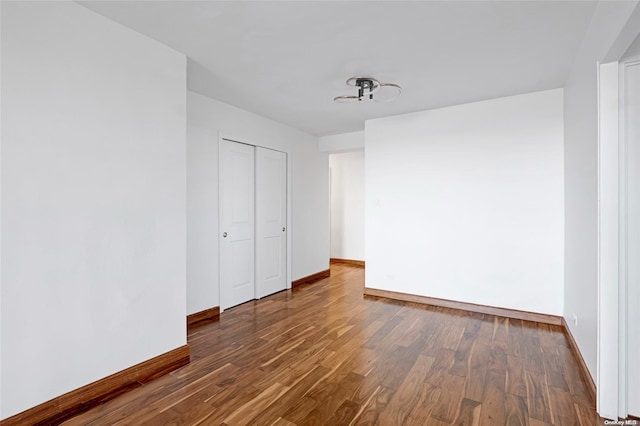 empty room with dark hardwood / wood-style floors