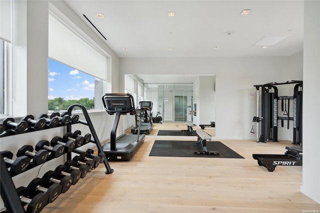 gym with light hardwood / wood-style flooring