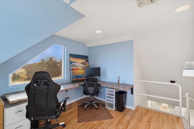 home office featuring light wood-type flooring and lofted ceiling