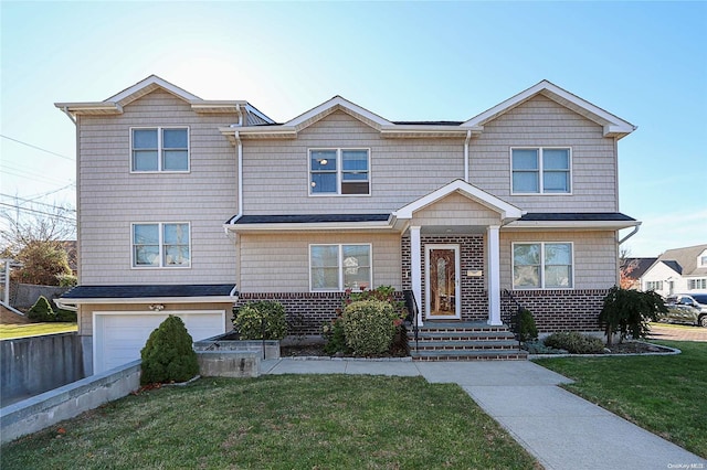 view of front facade with a front yard and a garage