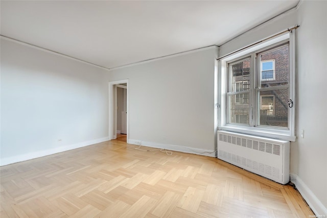 empty room with radiator and light parquet flooring